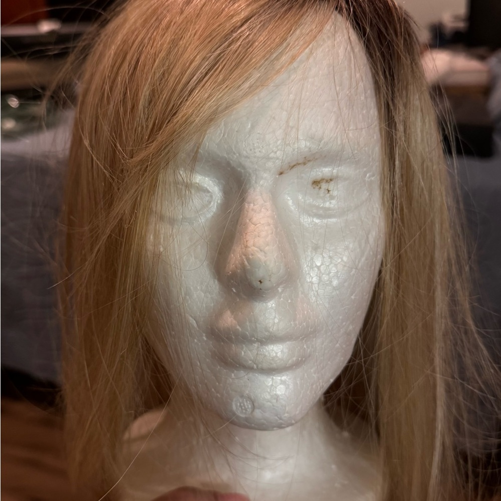 Light blonde hair topper with four clips. Excellent condition.